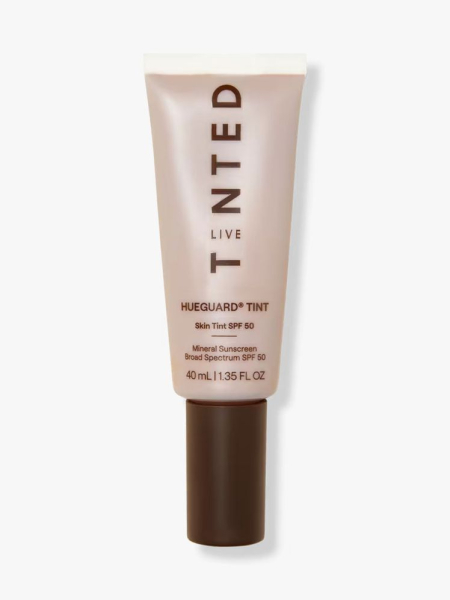 Beige bottle of Live Tinted Hueguard Skin Tint SPF 50 with a brown cap on a light gray background